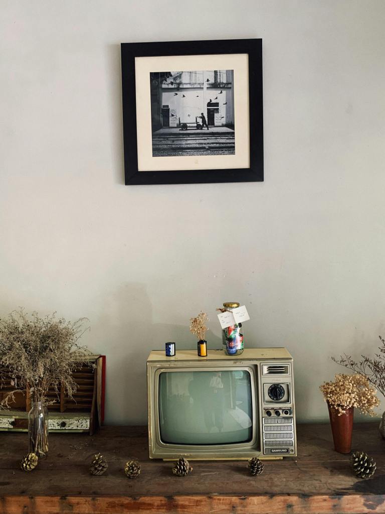 Indian family gathered in a living room watching television together, reflecting shared Doordarshan evenings in the 90s