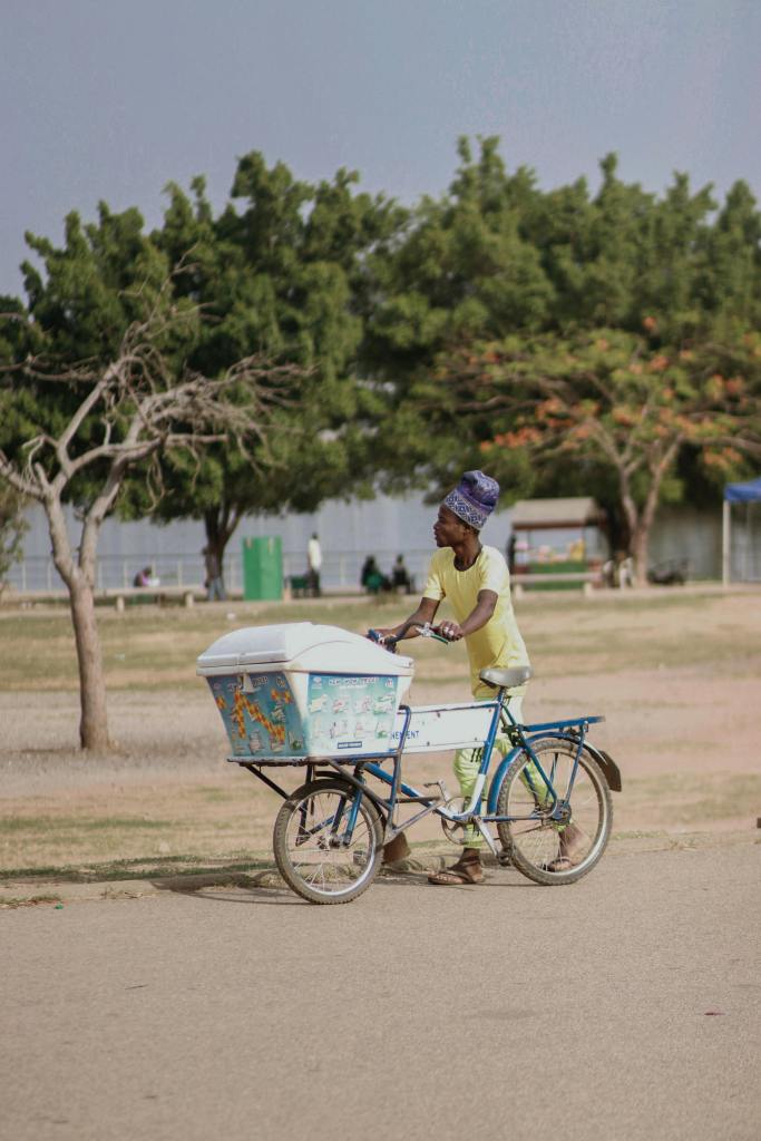 Street vendor in India selling ice from a glass dome, capturing the joyful chaos of childhood treats